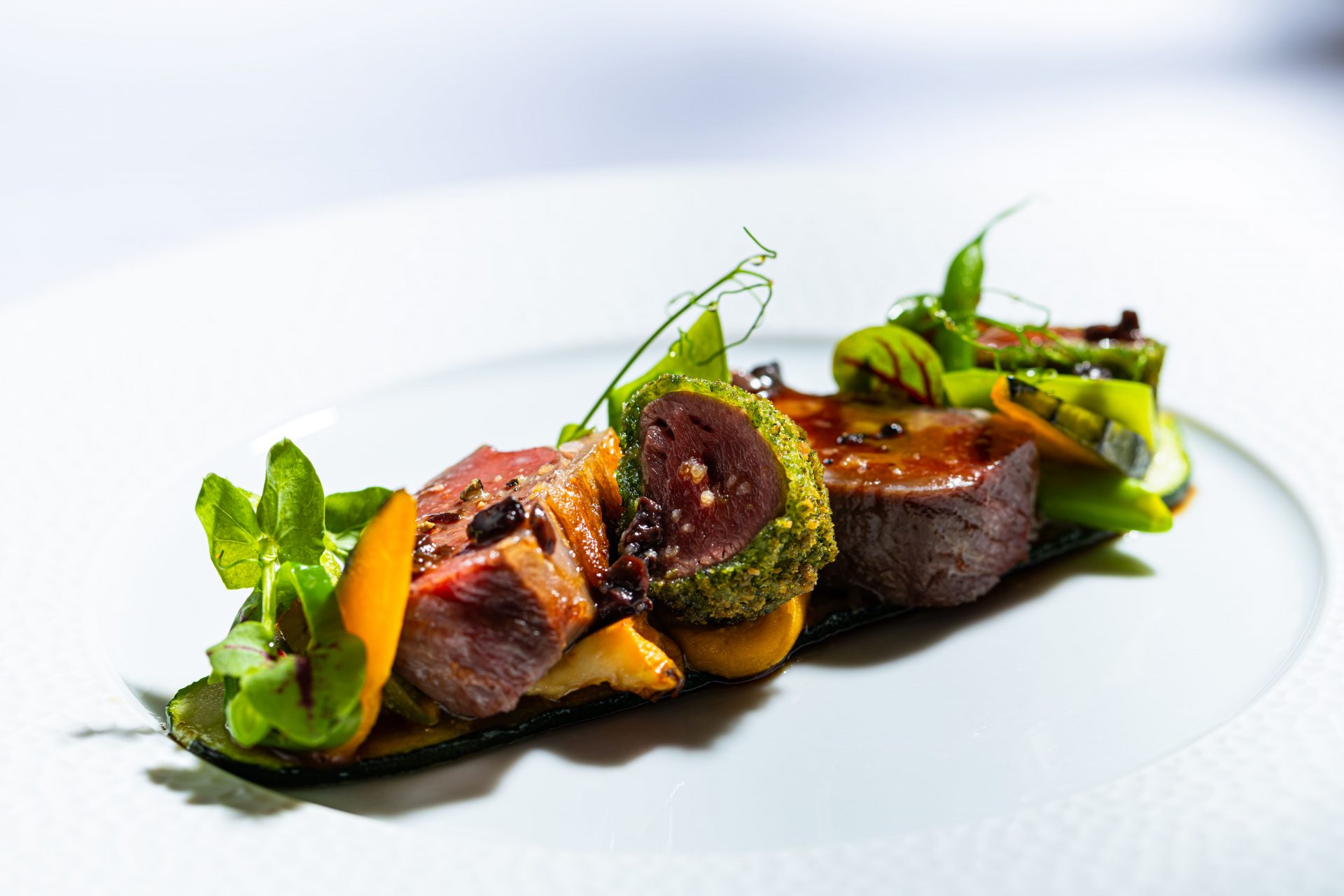 Roasted lamb with summer vegetables and olive jus